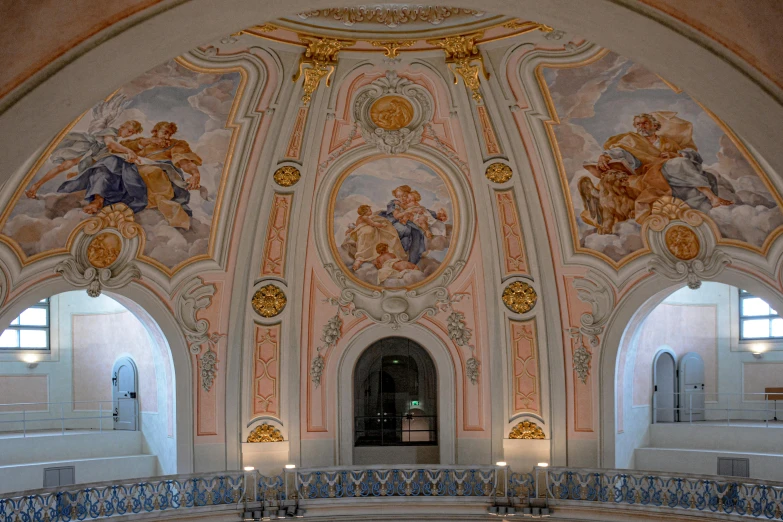 a building with an ornately painted ceiling and chandelier