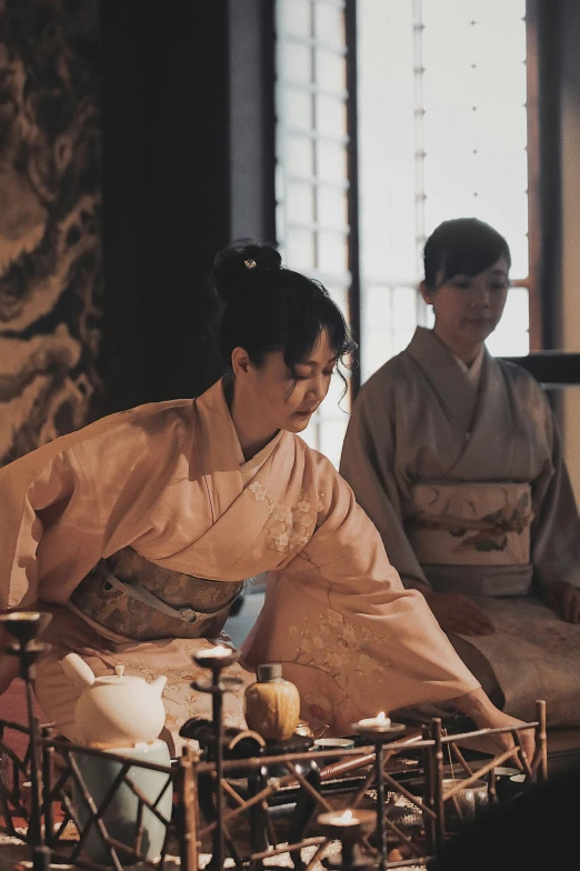 a woman in kimono holding a glass bowl