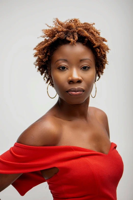 an african american woman with curly hair looking at the camera