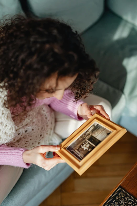 a girl holding a small po in her right hand