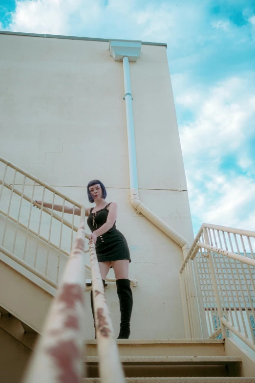 a woman standing on top of a stair case