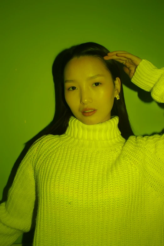 a woman in a bright green sweater with long hair