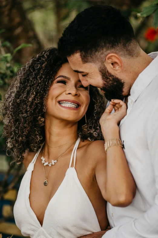 a young couple is laughing and laughing together