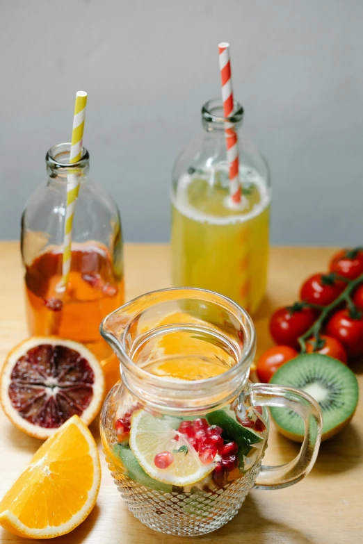 the pitcher, two glasses and three pieces of fruit have strawberries in them