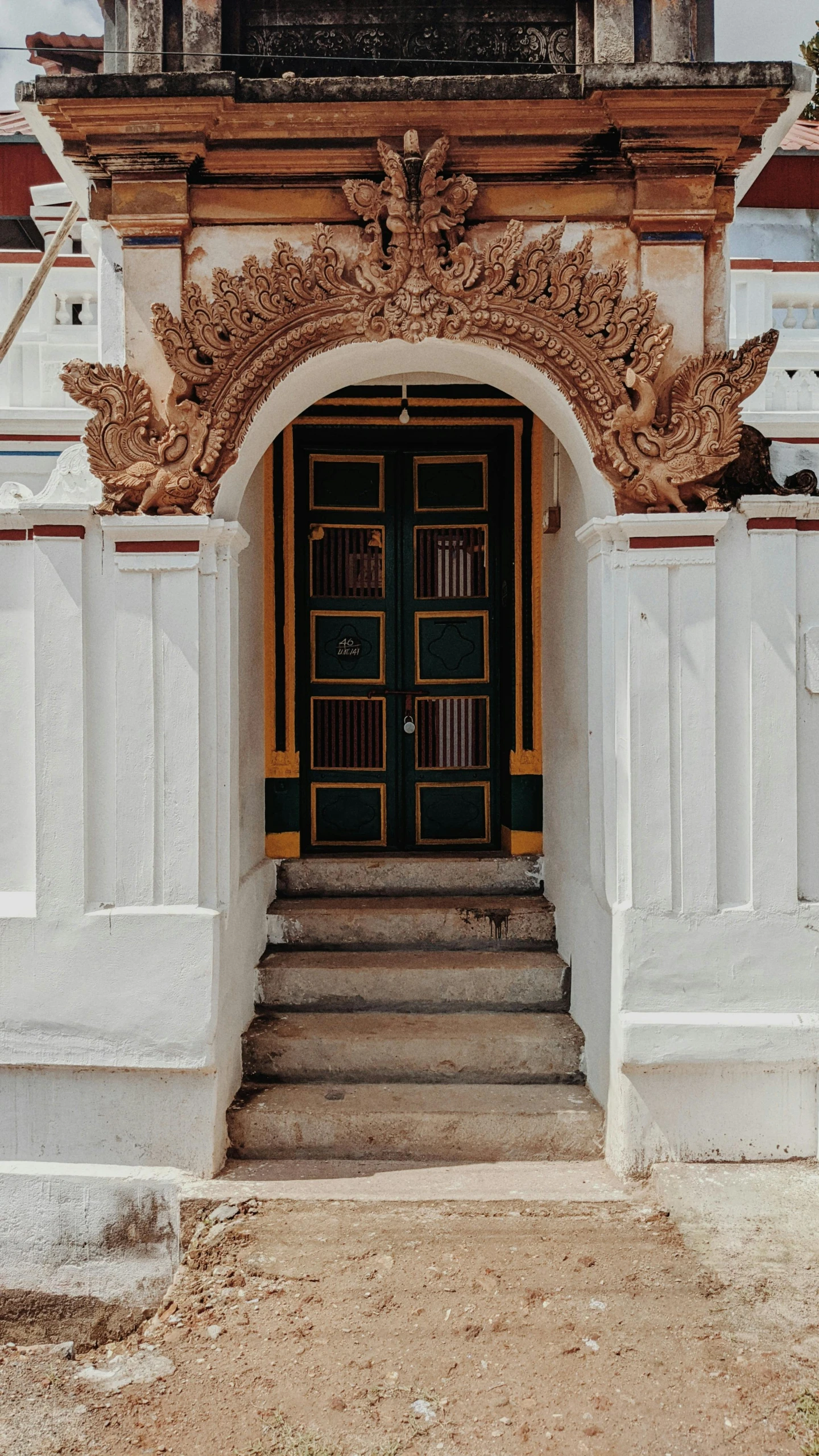 a front door with a big arched doorway