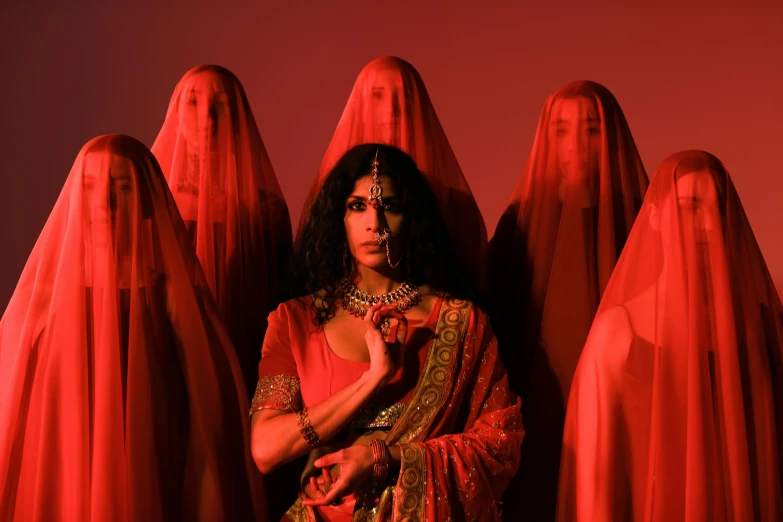 a woman in a red costume surrounded by many large red, rectangular objects