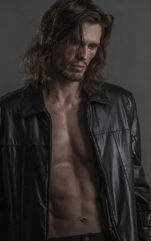 an image of a male with long hair and a shirtless body