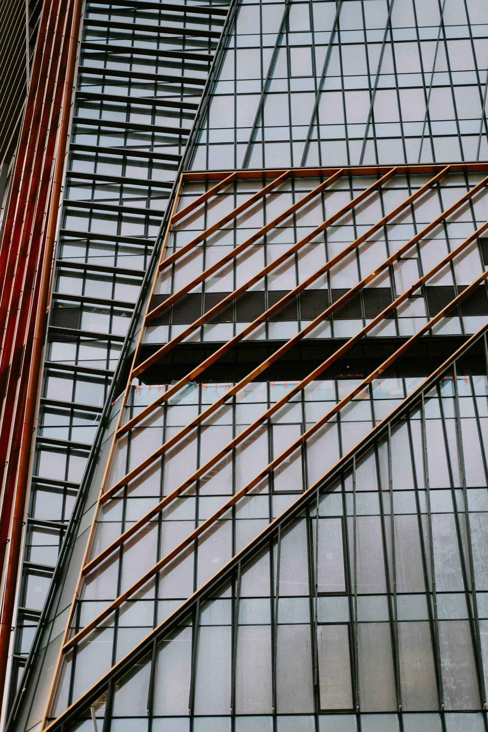 a triangle of metal and red pipes against a blue wall