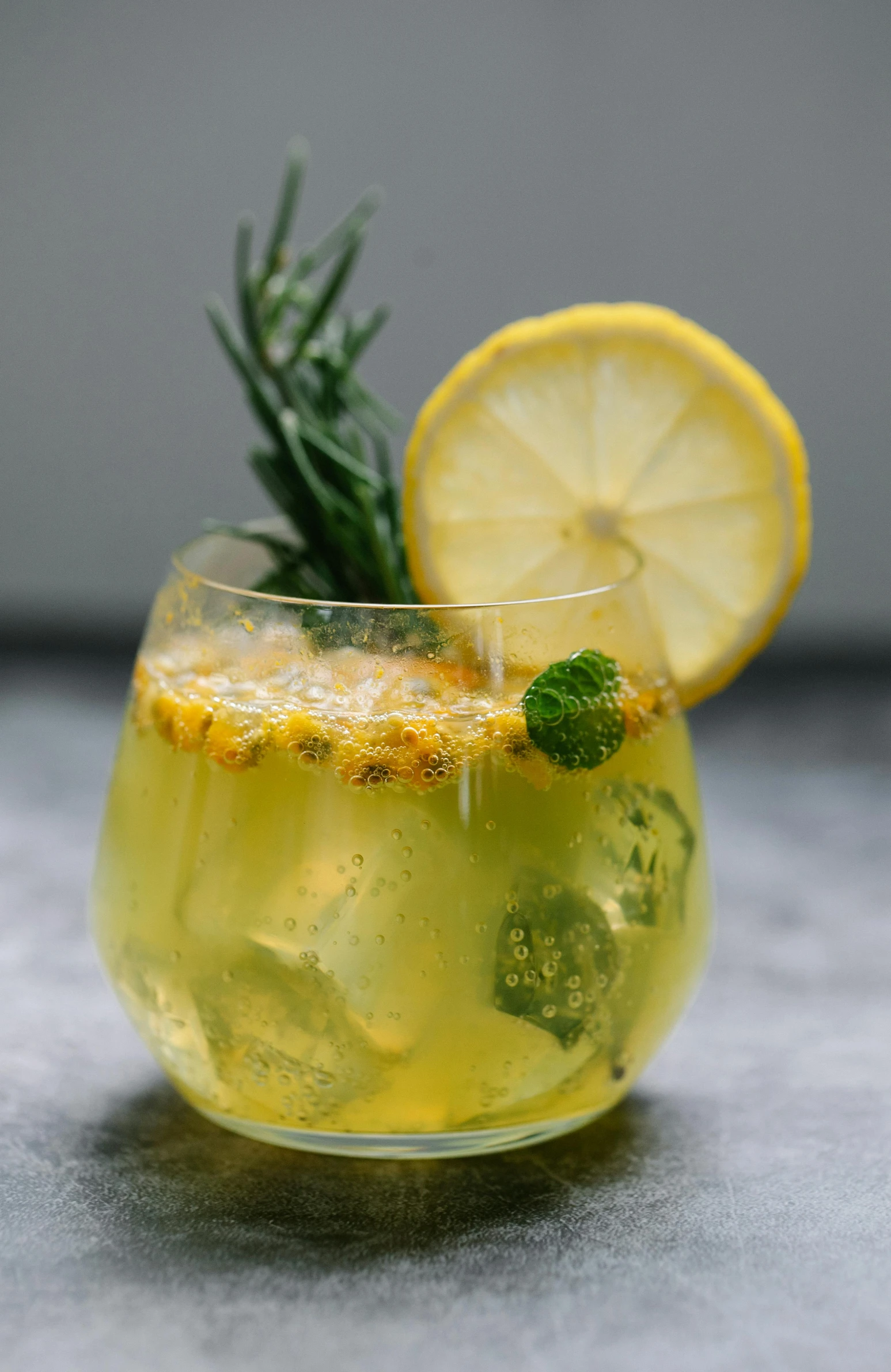 a close up of a lemon cocktail in a glass with a garnish