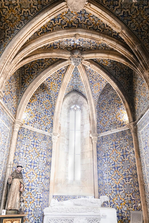 an ornate cathedral with blue and yellow tiles, and a white shrine