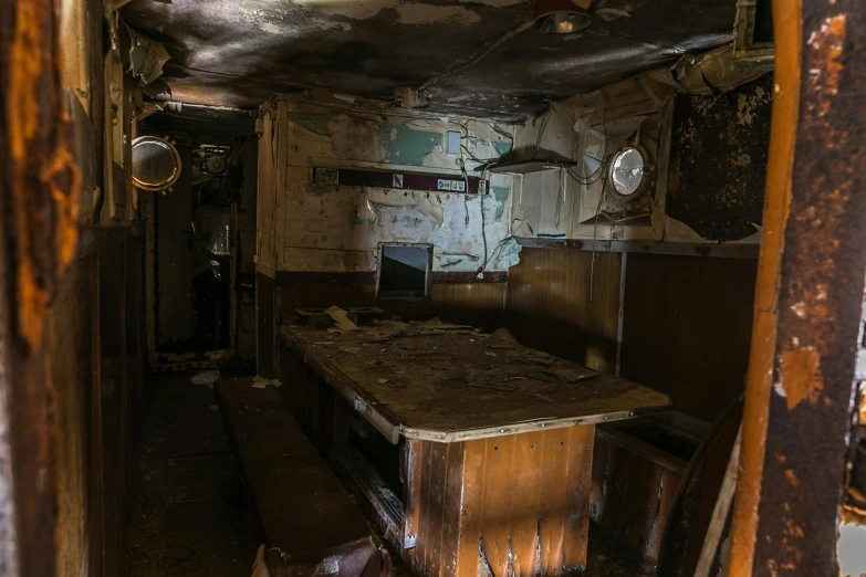 an abandoned kitchen with dirty walls and paint peeling