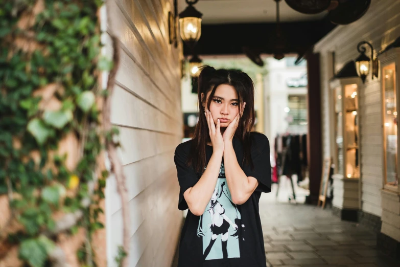 a woman is standing outside while holding her hands together