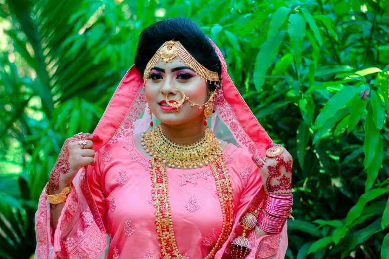 a person wearing a veil and wearing jewelry in a forest