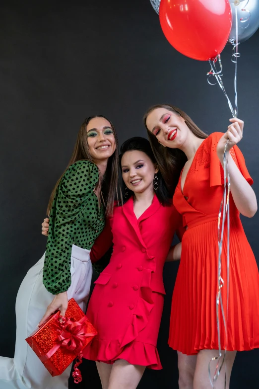 a group of women pose together for a picture with balloons