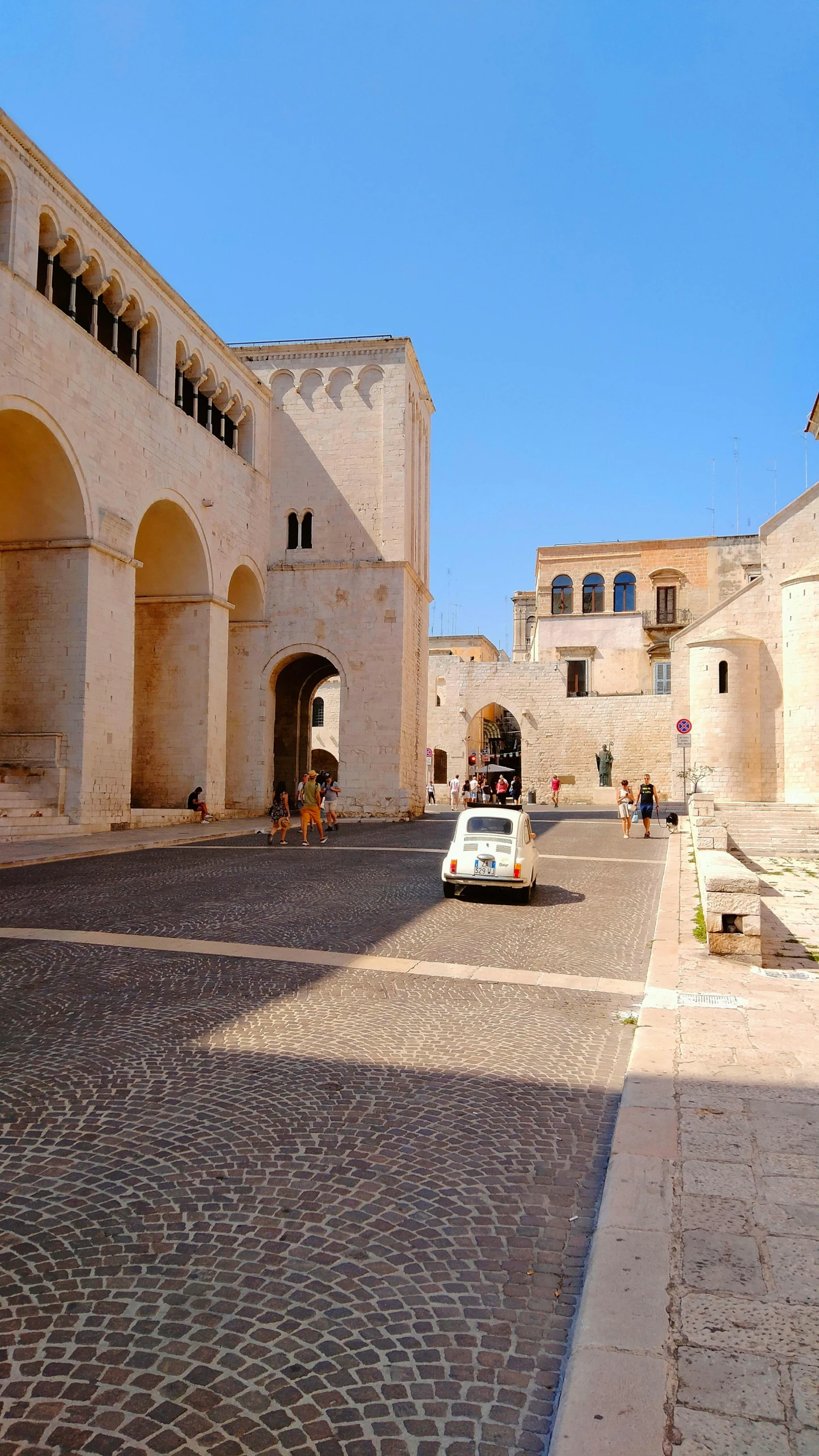 a street scene with an old white van