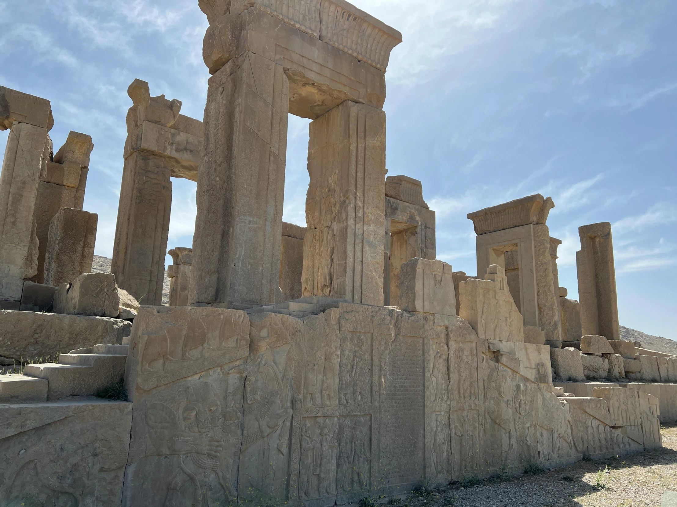 many stone pillars are standing near each other