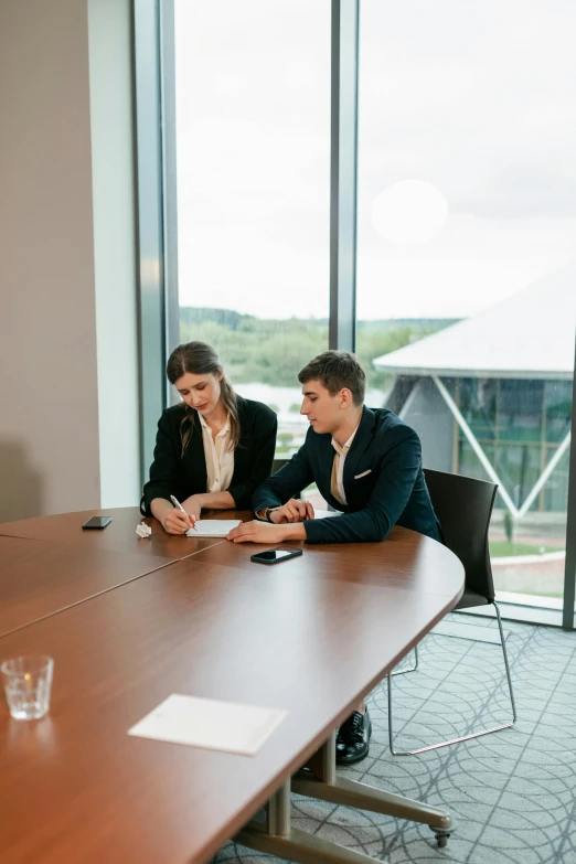 two people are sitting at a table