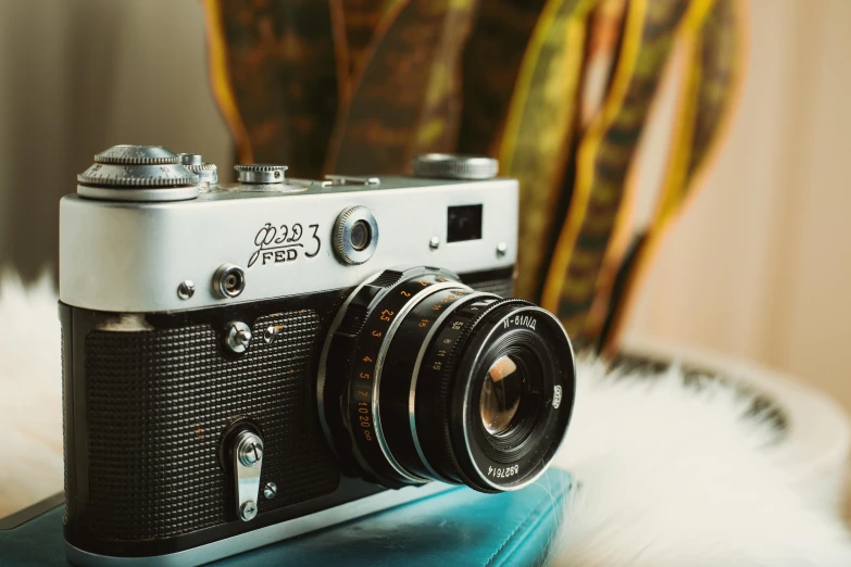 a small white and black camera sitting on a tray