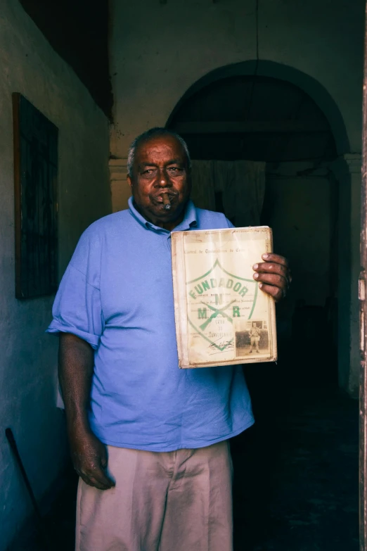 a man with a box in his hands is posing for the camera