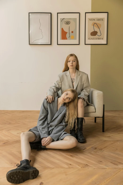 a young woman is getting hair styled by an older lady