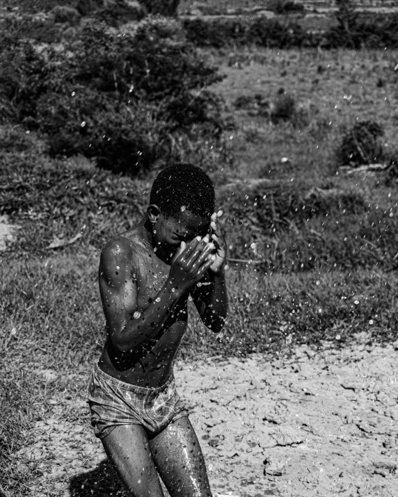 the young man is covered in mud while he plays in the water