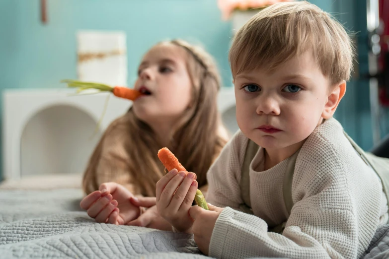 a girl is trying to eat some carrots