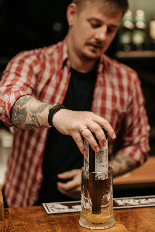 a man holding a glass filled with a liquid