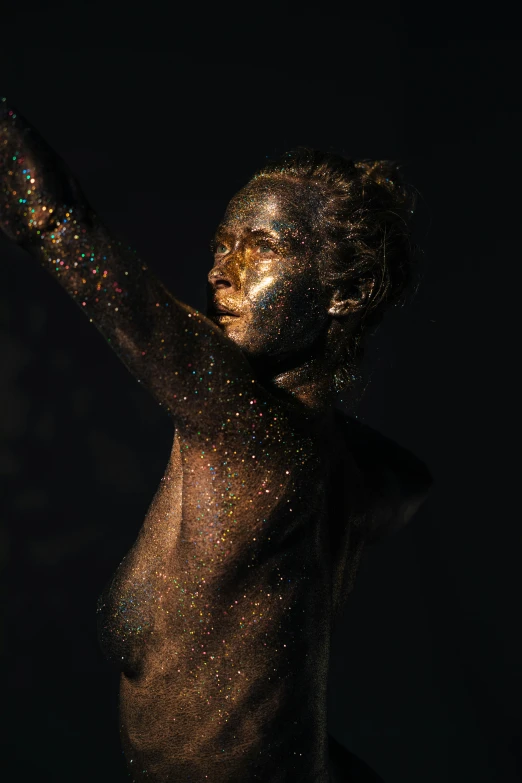a woman covered in glitter with her arms outstretched