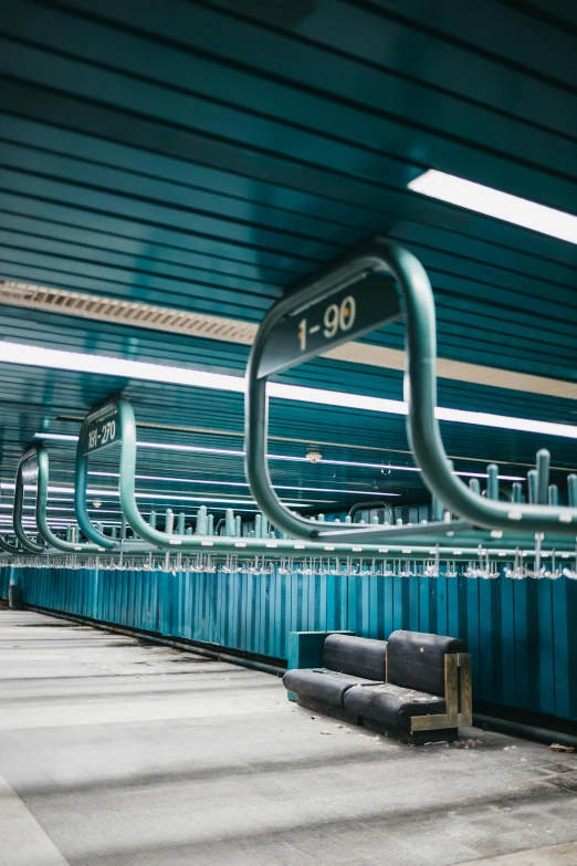 blue, industrial parking spaces are lined with steel pipes