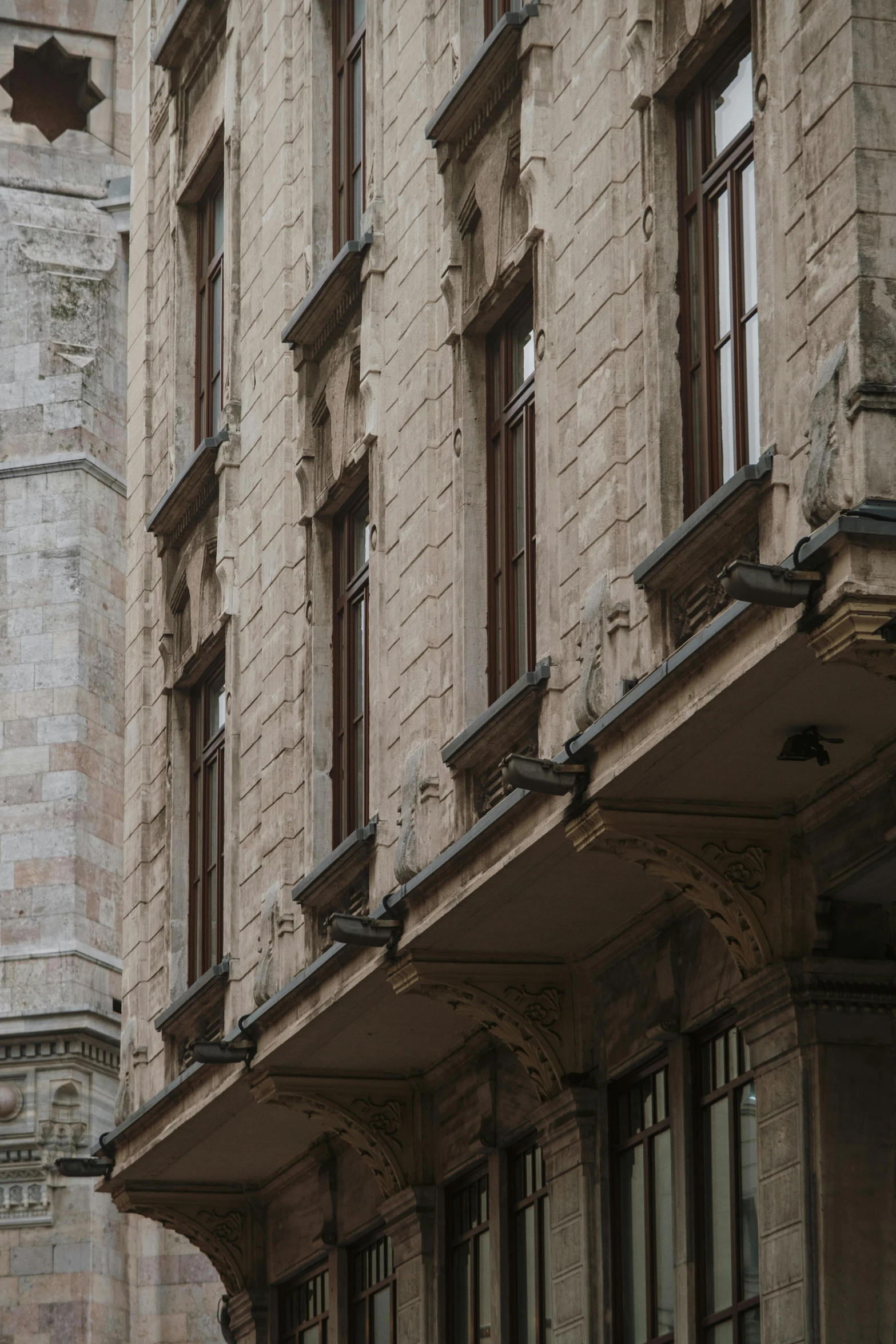 a very old style stone building with many windows