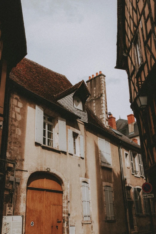 a view of a wooden door and windows on an old house