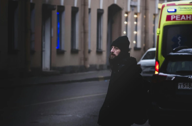 a man is standing by an ambulance in a street