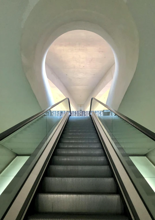an escalator has a long length of stairs leading up it