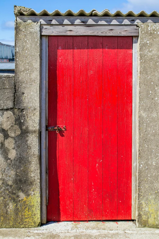 the red door is next to a wall