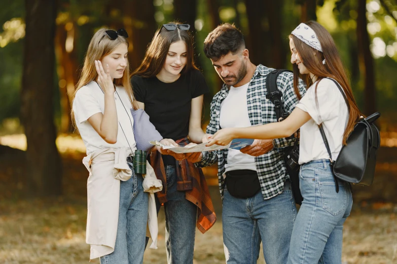 three people are looking at a paper and smiling