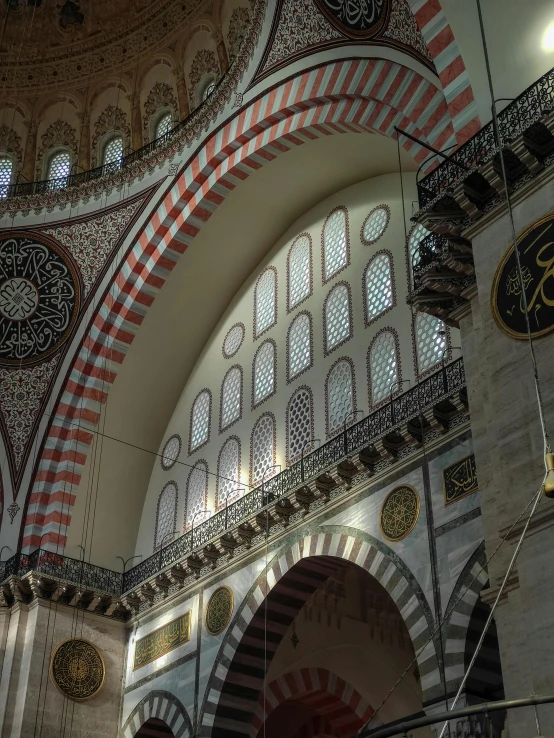 a view inside of a building showing a clock and arches