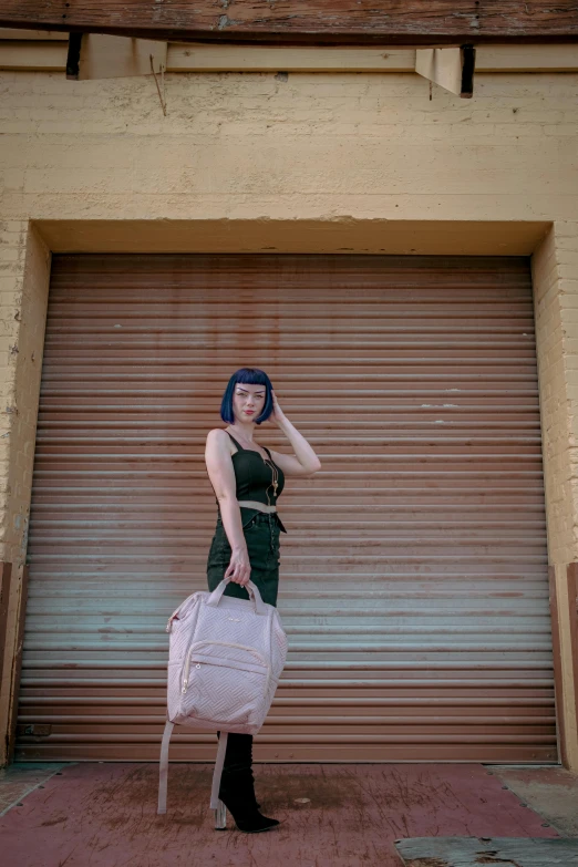 a woman in a black dress holding a white bag