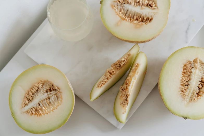 a piece of melon next to another half sliced