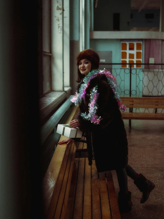 a smiling woman is wearing a colorful light necklace