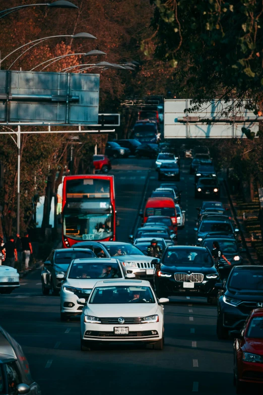 a street filled with lots of cars and a large red truck