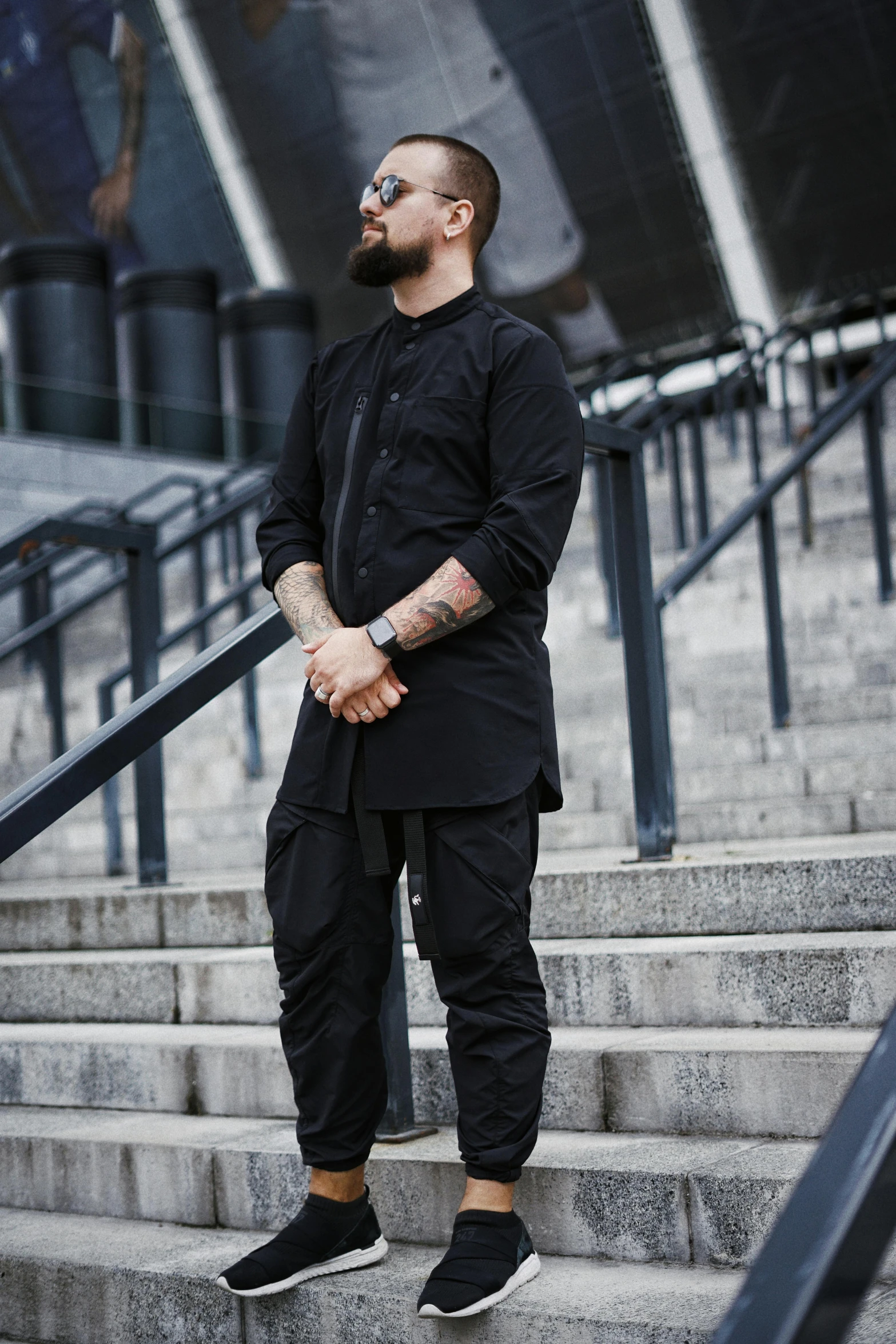 a man with a beard standing on some steps