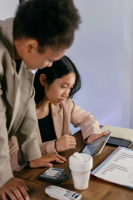 a man looking at his cell phone while a woman watches