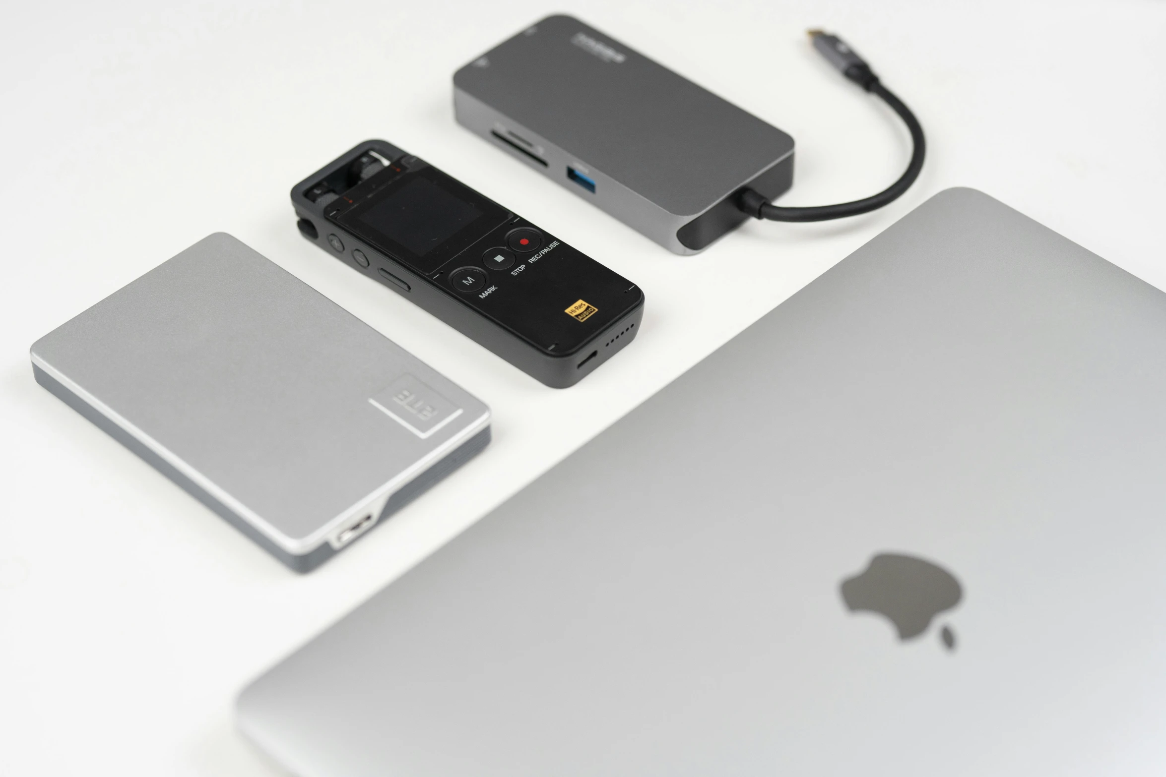 a laptop, battery and cellphone are on the table