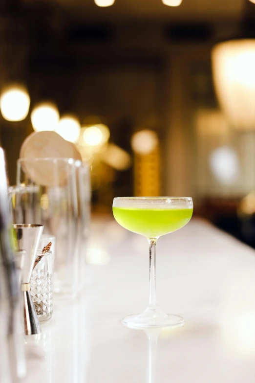 a glass sitting on top of a table filled with alcohol