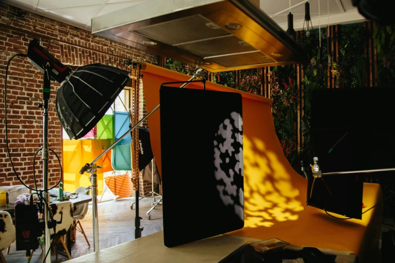 a po studio with lighting set up and umbrella