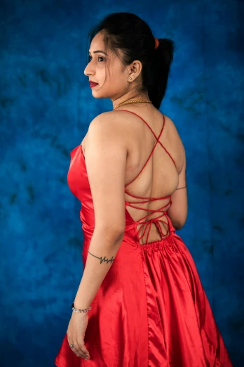 a woman in a red dress poses for a picture