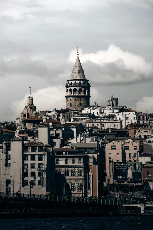 the sky is cloudy over a city on the hill side