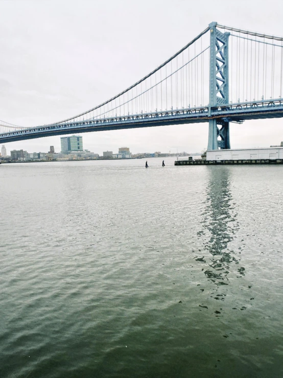 a boat is coming under the bridge on the water