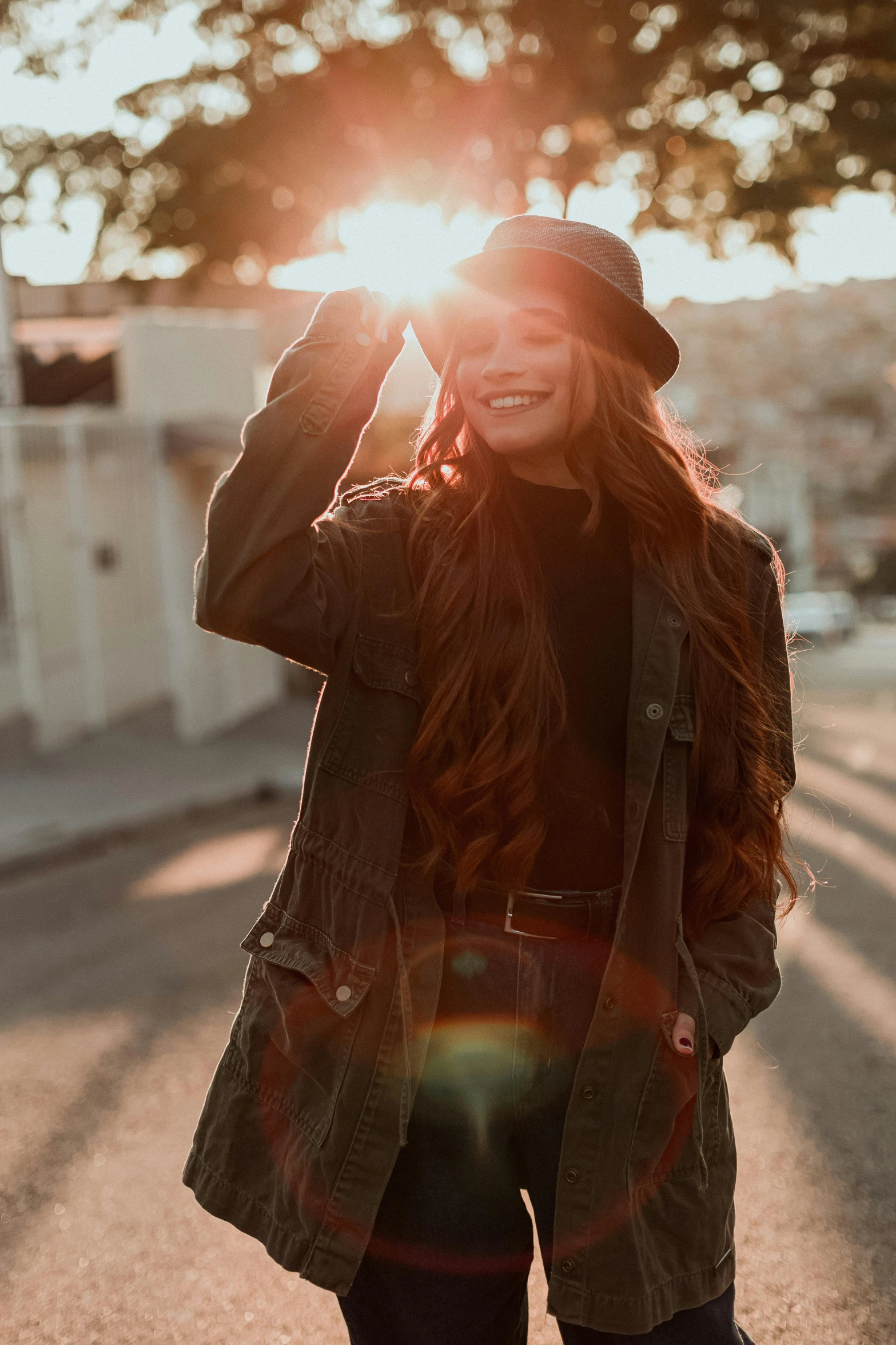 a woman walking down the road wearing a jacket