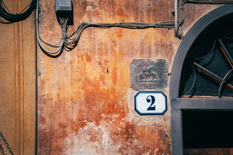 a door with a number plate next to a window